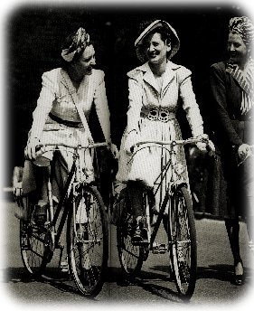 An Image of Two Women on Bicycles Talking